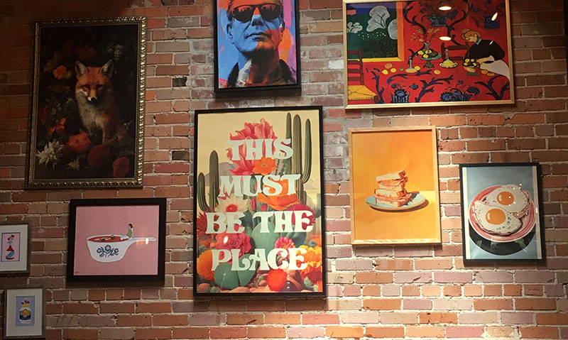 A wall of random art at a restaurant
